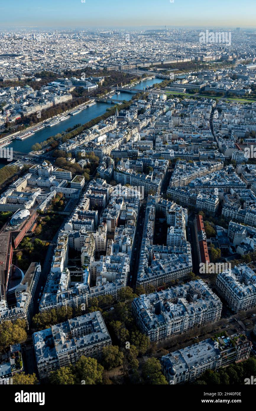 Aerial view looking down at colorful rooftops of buildings and streets over Paris, France Stock Photo
