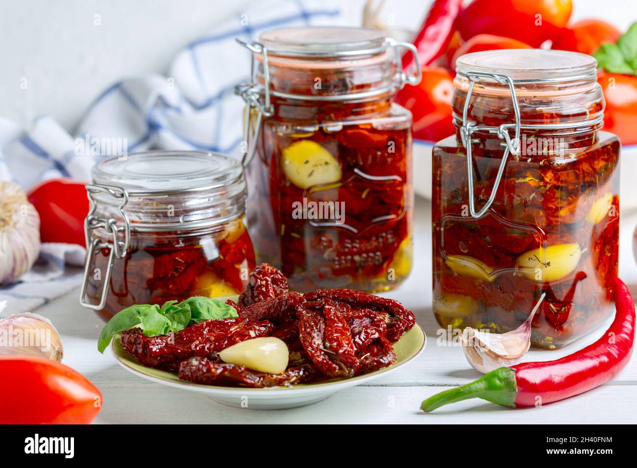 Dried tomatoes with herbs and olive oil. Stock Photo