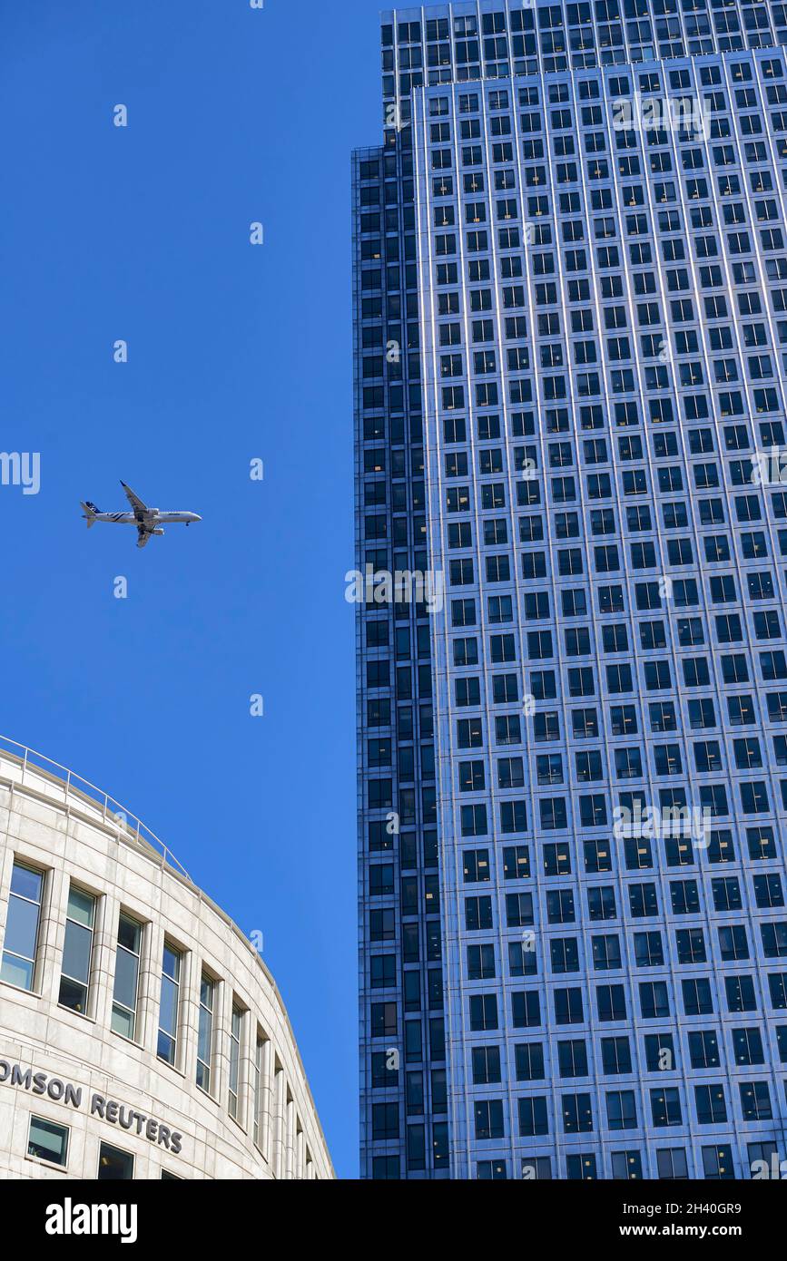 View of an Alitalia plane approaching the airport between the Canary Whaf office buildings, aerial transport, London, UK Stock Photo