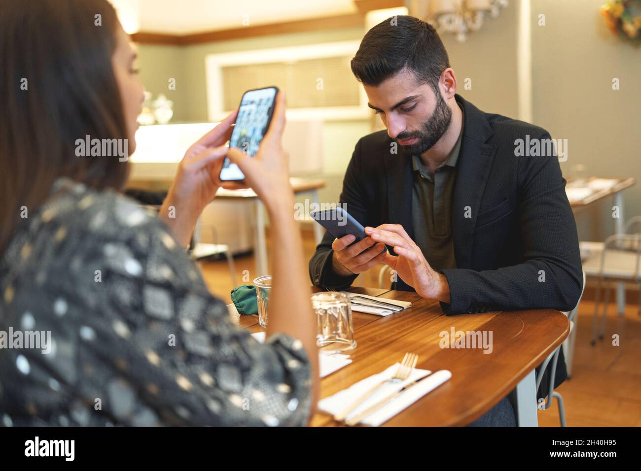 Premium Photo  Boyfriend sits engrossed in playing online games on his  smartphone, ignoring his girlfriend waiting.