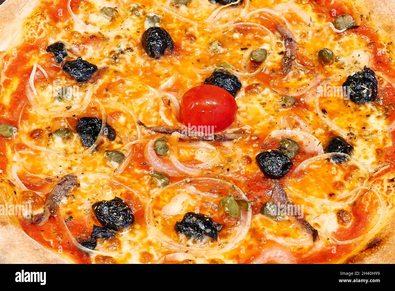 Overhead close-up shot of textured Siciliana pizza Stock Photo - Alamy
