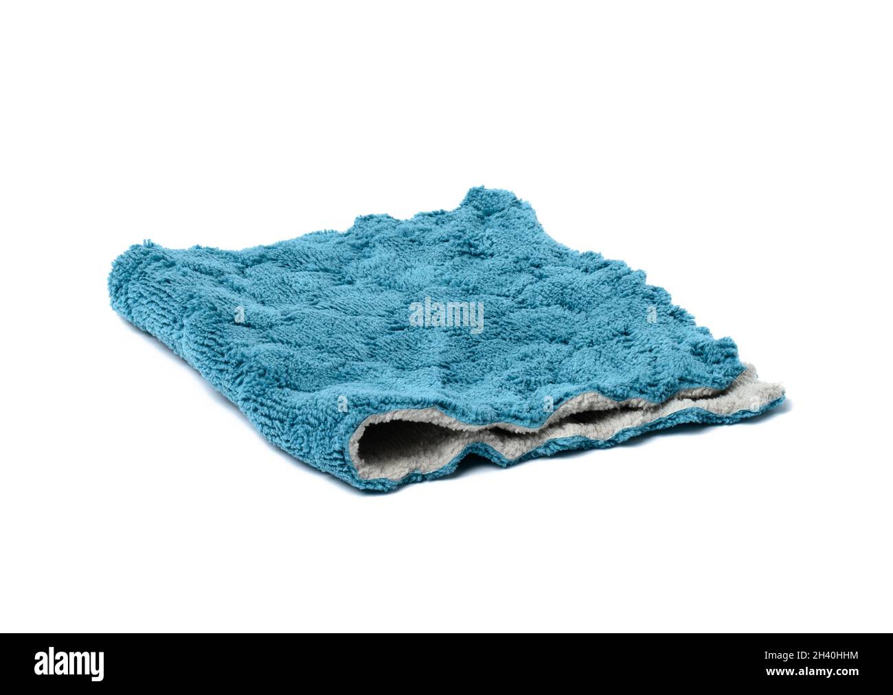 Folded kitchen blue towel isolated on white background. Terry cloth Stock Photo