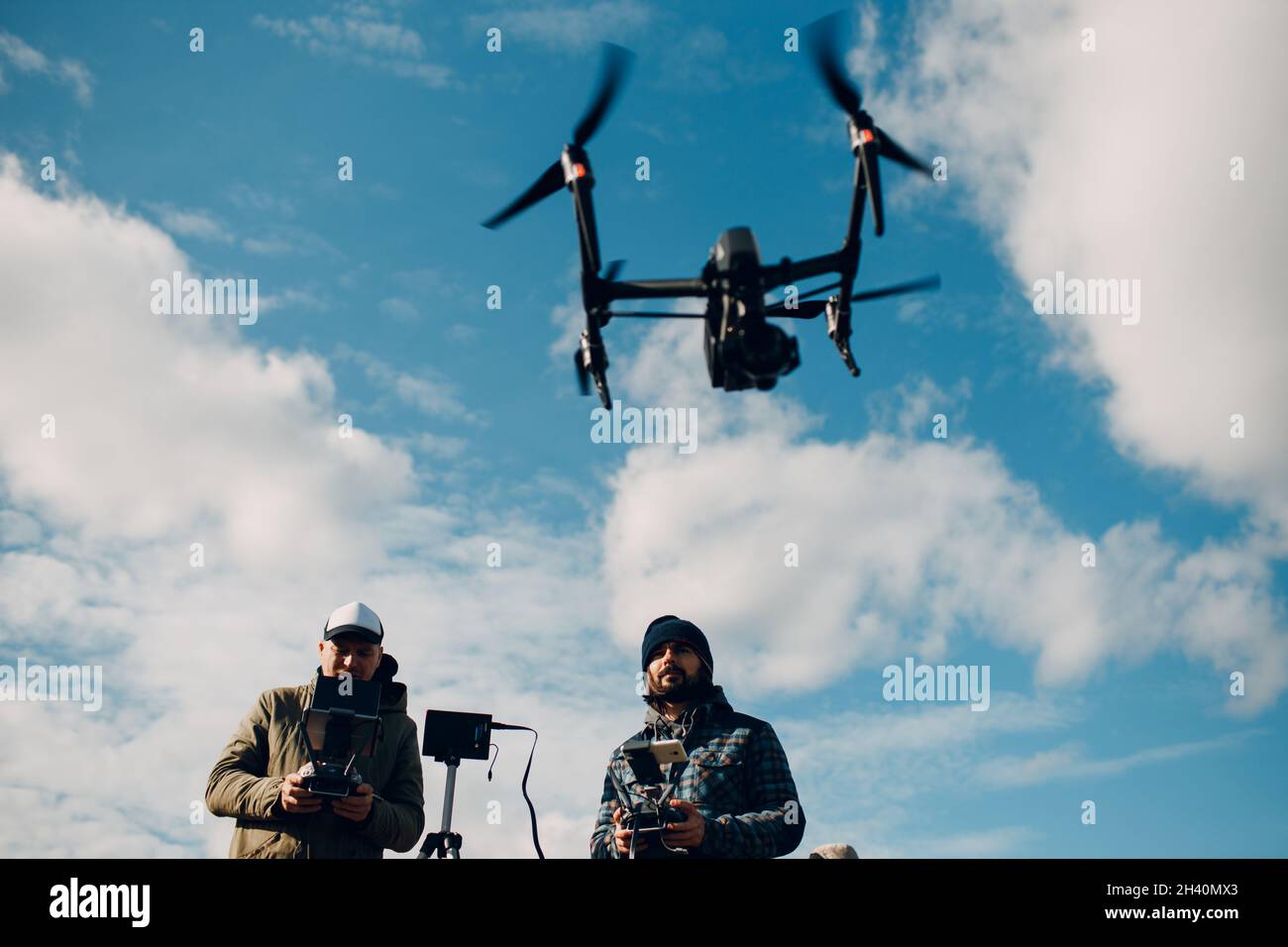 Man pilot controlling quadcopter drone with remote controller pad Stock Photo