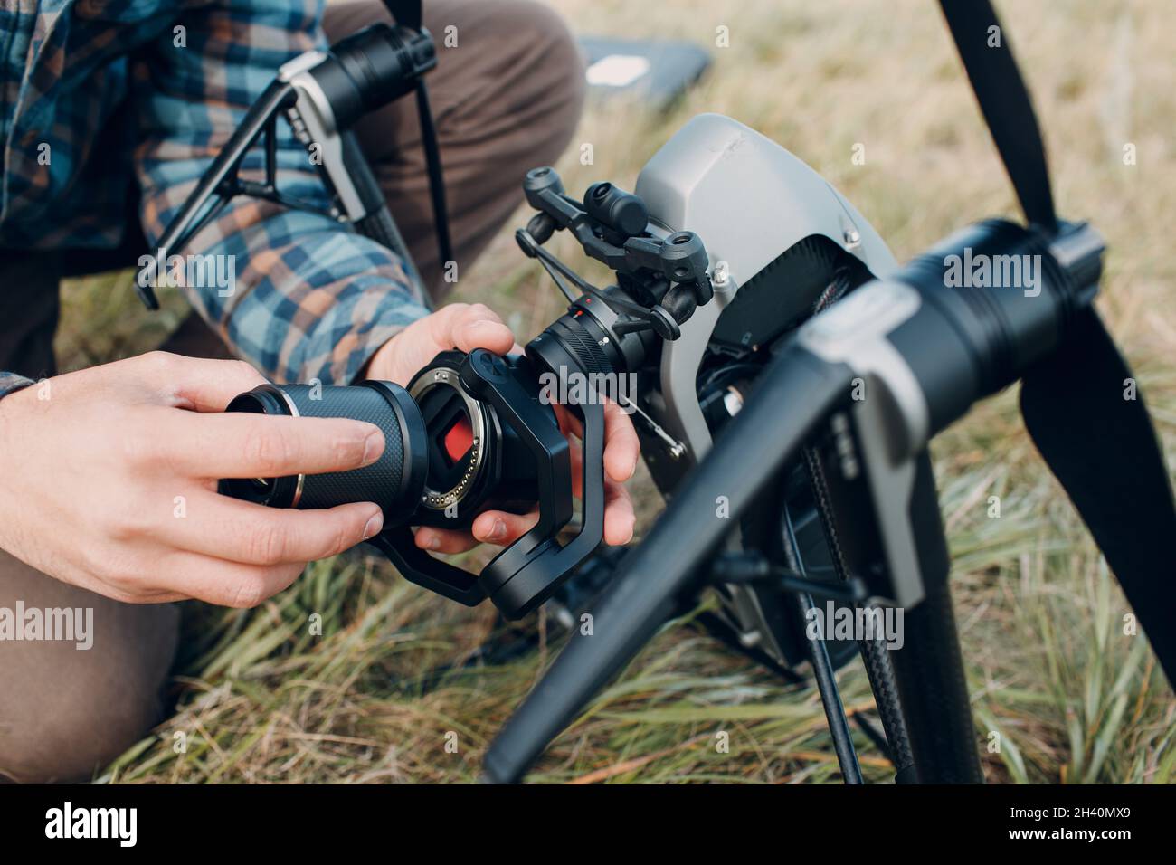 Man pilot checking quadcopter drone before aerial flight and filming. Stock Photo