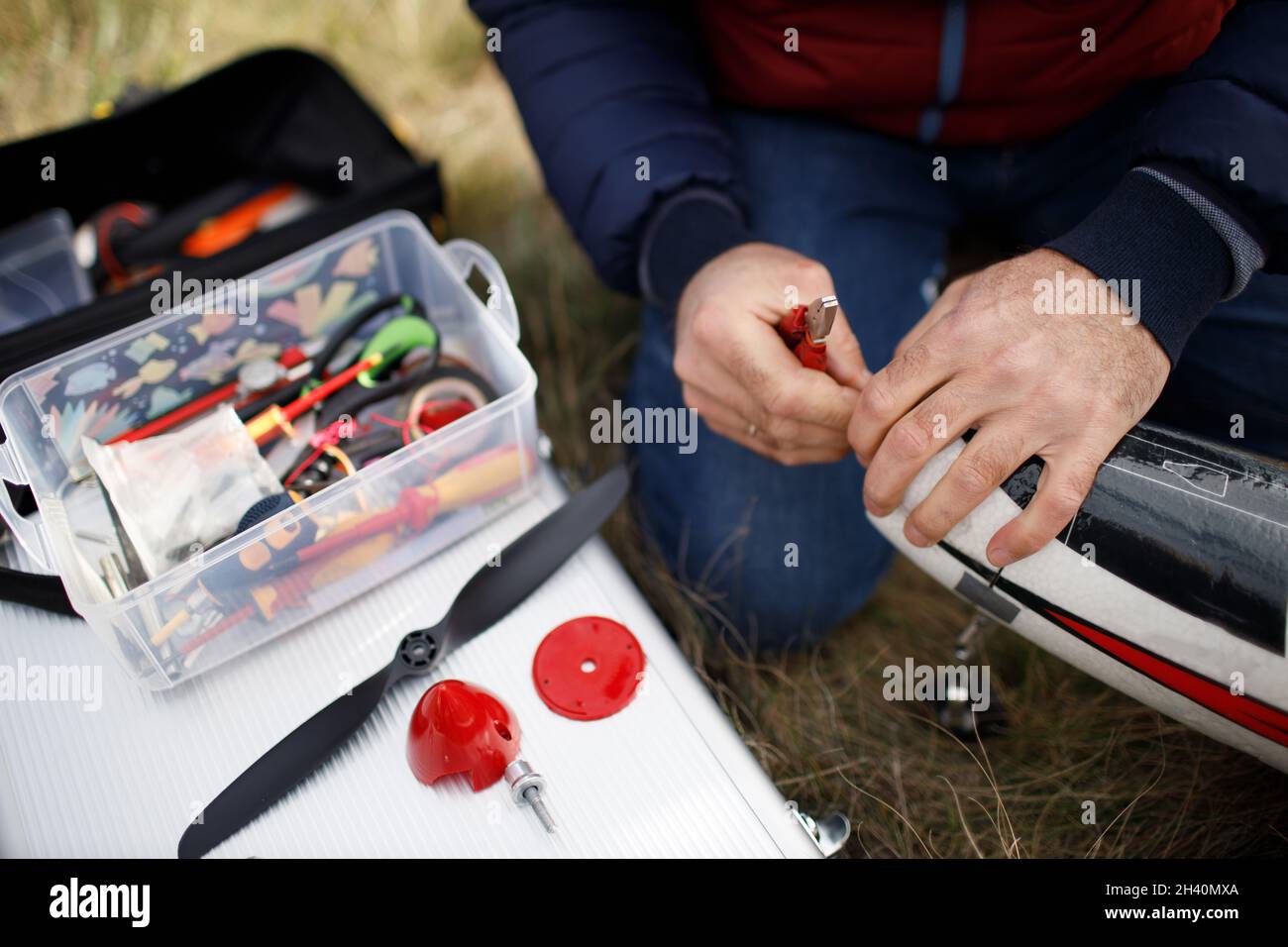 Radio control rc airplane toy model on ground man repair blade Stock Photo