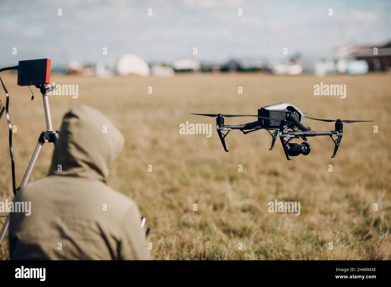 Man pilot controlling quadcopter drone with remote controller pad Stock Photo