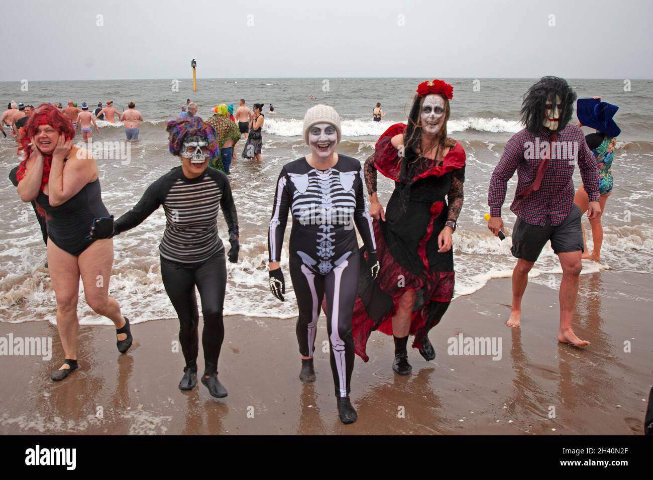 Portobello, Edinburgh, Scotland, UK. 31st October 2021. Spooktacular dip at  seaside this Halloween. To celebrate the launch of Scottish authors Anna  Deacon and Vicky Allan's new expert guide on The Art of