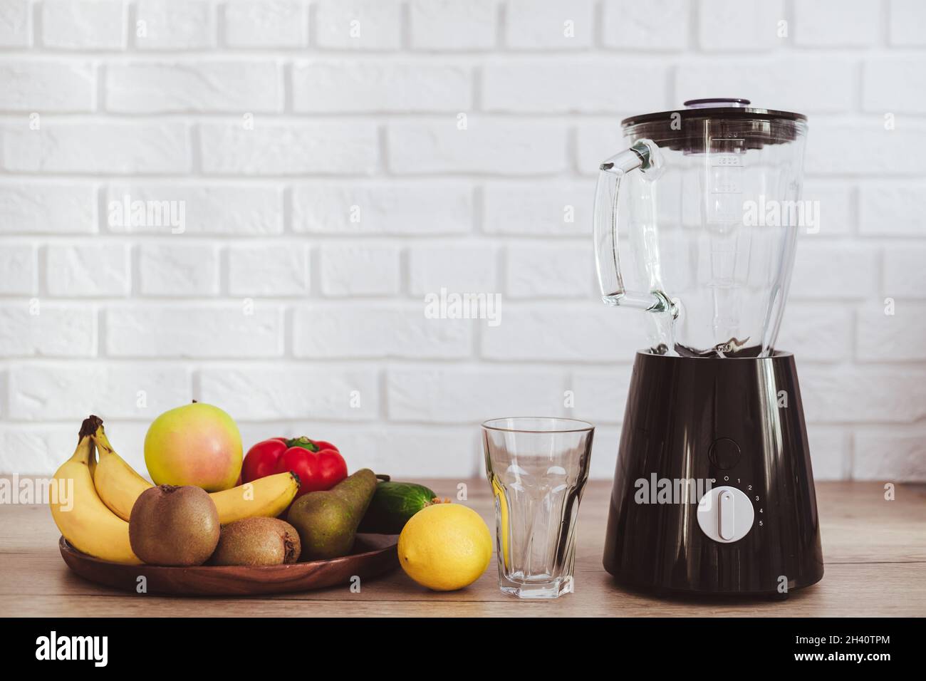 Blender with ingredients for smoothie on table in kitchen Stock Photo
