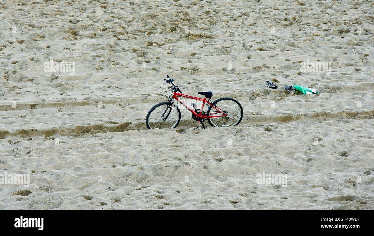 Bicycle stuck in the sand on the beach of Sant Adria del Besos