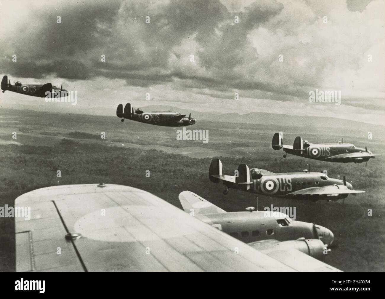 Vintage photo circa 1942 of a flight of Lockheed Hudson Mk.I bombers of the Royal Australian Air Force number 1 squadron flying over Malaya during the Japanese invasion of Malaya and the fall of Singapore.  No. 1 Squadron launched a series of assaults on the Japanese forces, becoming the first aircraft to make an attack in the Pacific War. The Hudsons sank a Japanese transport ship, the IJN Awazisan Maru, and damaged two more transports, the Ayatosan Maru and Sakura Maru, for the loss of two Hudsons, an hour before the attack on Pearl Harbor Stock Photo