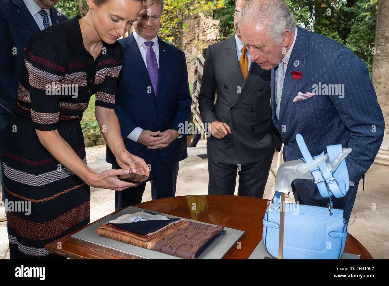 The Prince of Wales views The SMI Fashion Coalition's Digital ID, a virtual certificate that records each item's history with members of the Fashion Coalition, one of the SMI's ten Industry Coalitions which includes CEOs from some of the leading fashion houses including Giorgio Armani, Mulberry and Chloe at the Villa Wolkonsky Residence Gardens in Rome. Picture date: Sunday October 31, 2021. Stock Photo
