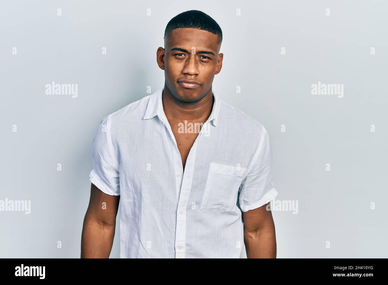 Young black man wearing casual white shirt depressed and worry for ...