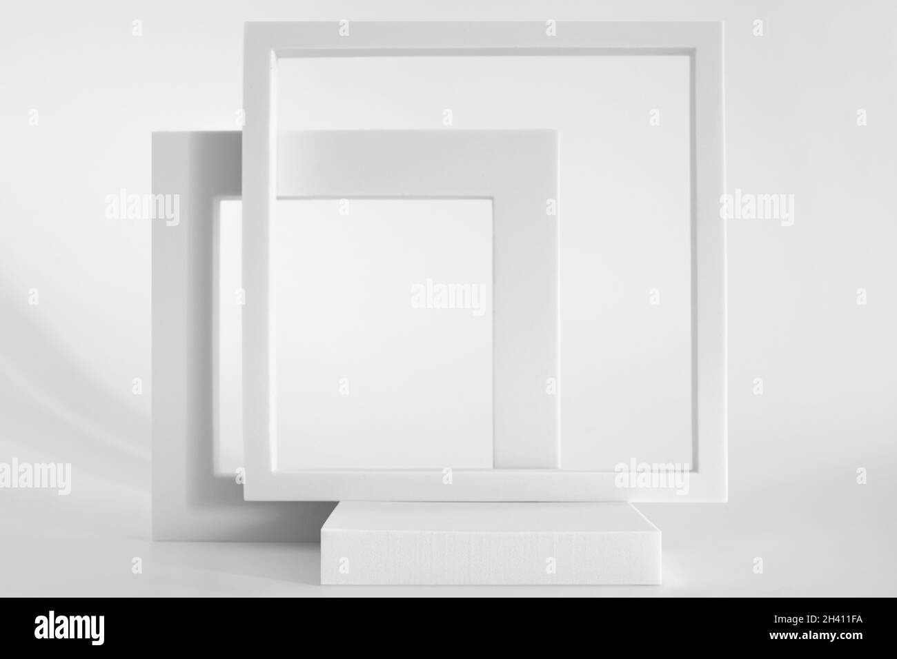 White podium on the white background, simple geometric forms. Podium for product, cosmetic presentation. Creative mock up. Pedestal or platform for Stock Photo