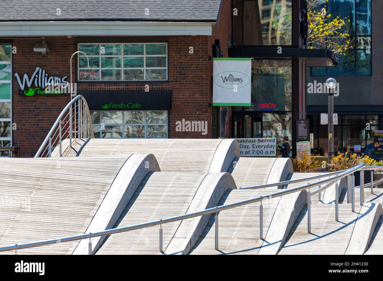 Simcoe Wavedeck and the Pier 4 building in the downtown waterfront. The wooden structure is an attraction for tourists and locals specially in the Sum Stock Photo