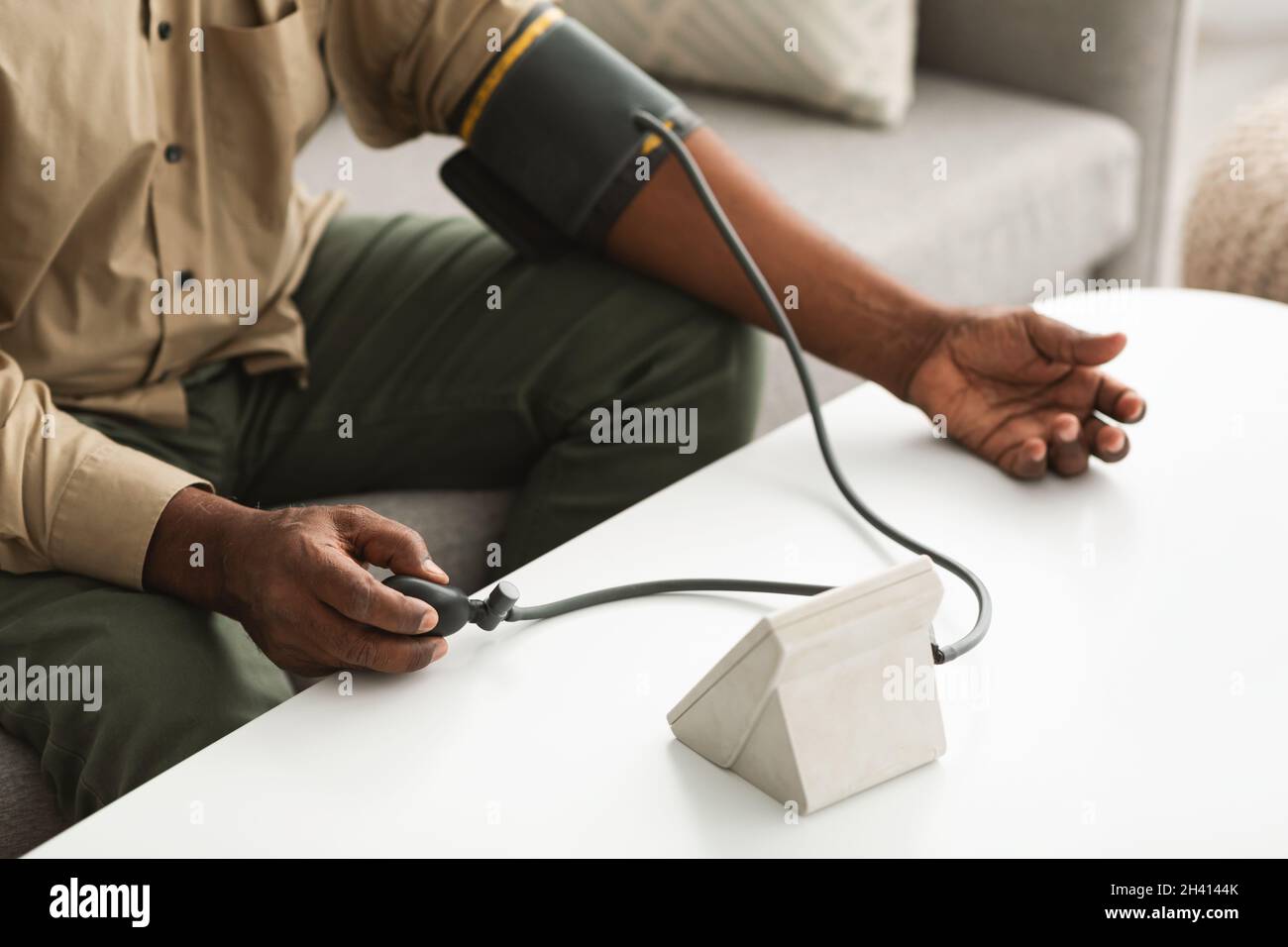 Unrecognizable African American Man Measuring Blood Pressure At Home, Cropped Stock Photo