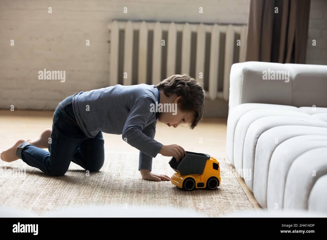 Happy little cute kid boy playing toy car at home Stock Photo - Alamy