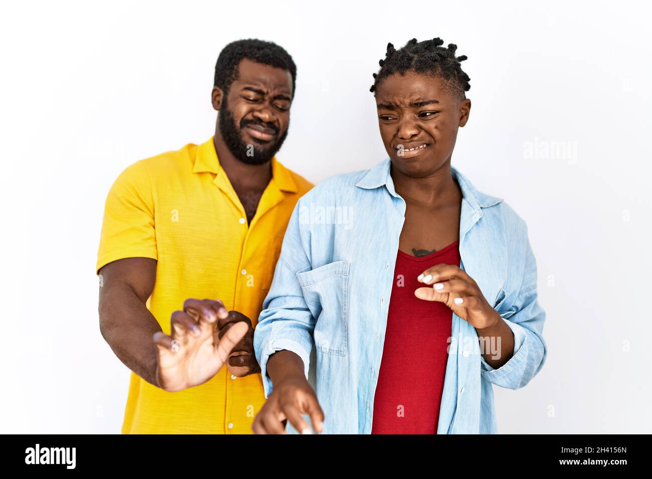 Young african american couple wearing casual clothes disgusted ...
