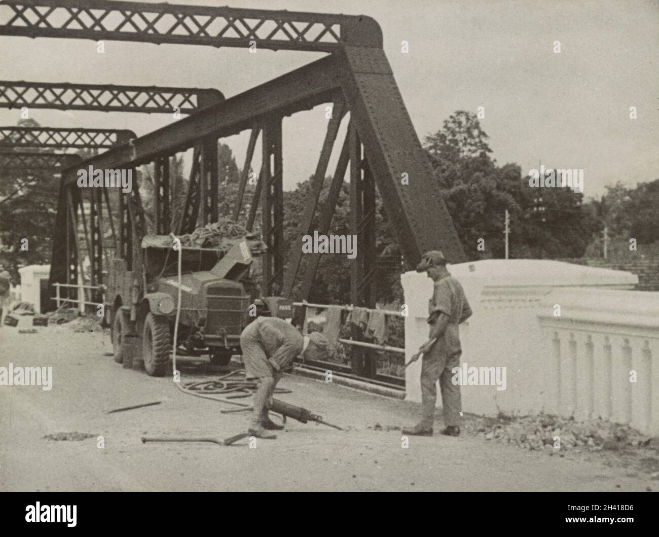 A vintage photo circa 1942 showing a soldiers of the British Army preparing to destroy a bridge near Kuala Lumpur Malaya as part of scorched earth policy to slow down the Japanese advance on the Malay peninsula Stock Photo