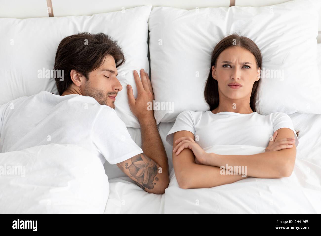 Angry unhappy sad caucasian millennial woman awake with crossed arms in