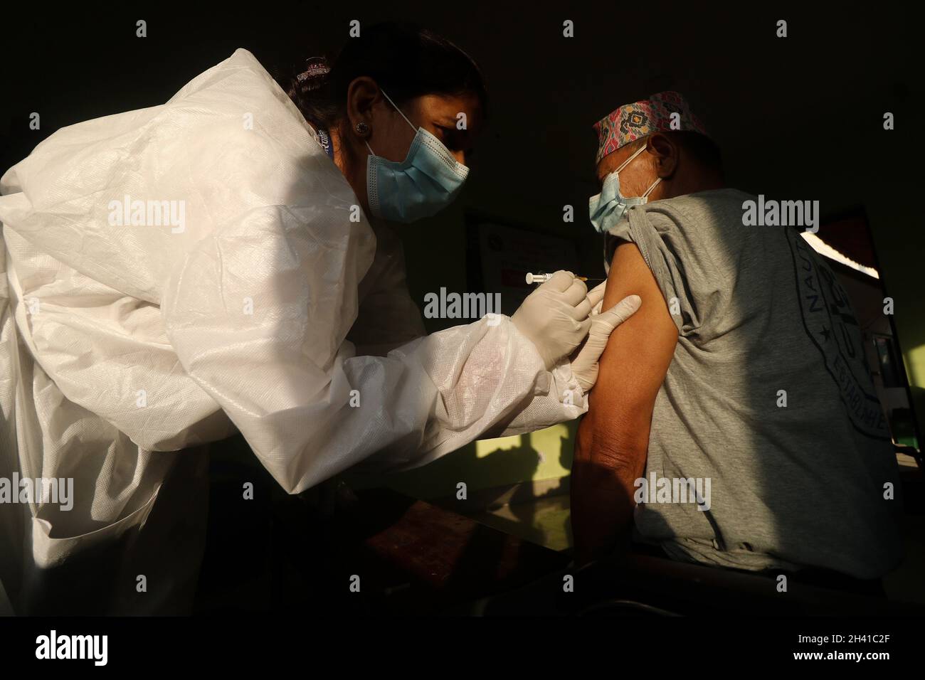 Kathmandu, NE, Nepal. 31st Oct, 2021. A Nepali paramedic inoculates a septuagenarian with anti-pneumonia vaccine (PCV-13) at a local vaccination center in Lalitpur District of Nepal on 31 October, 2021. The Lalitpur Metropolitan in first phase of the campaign has started inoculation drive that targets people above 74 years to be jabbed against pneumonia in wake of rising COVID-19 cases and dropping mercury in recent days in the Himalayan Nation. (Credit Image: © Aryan Dhimal/ZUMA Press Wire) Credit: ZUMA Press, Inc./Alamy Live News Stock Photo