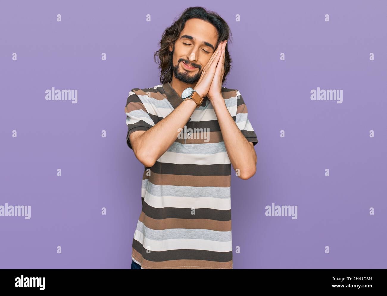Young hispanic man wearing casual clothes sleeping tired dreaming and ...