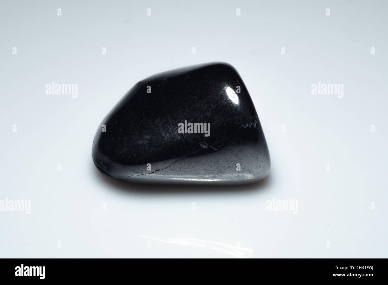 natural black shungite cabochon on background Stock Photo