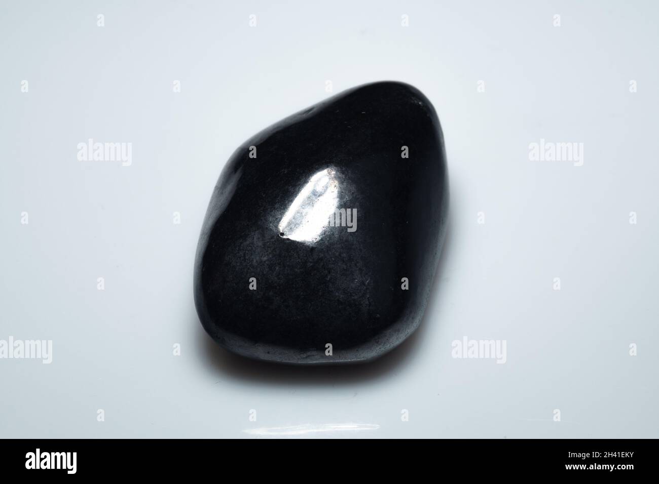 natural black shungite cabochon on background Stock Photo