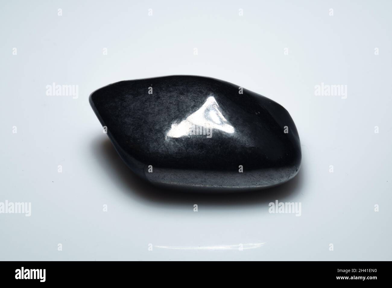 natural black shungite cabochon on background Stock Photo