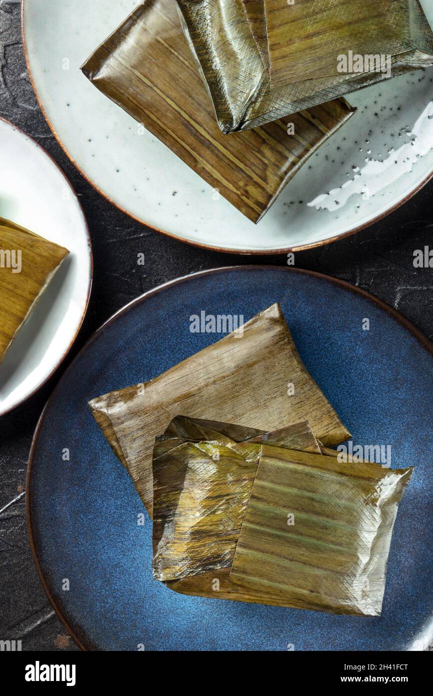 Tamales oaxaquenos, traditional Hispanic dish, wrapped in green leaves