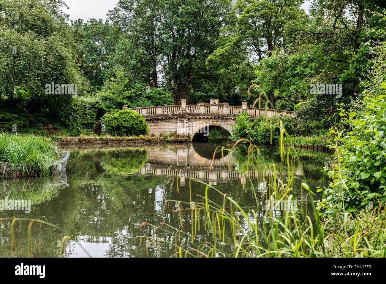 The lake and bridge in Pittville Park in Cheltenham in Gloucestershire, England Stock Photo