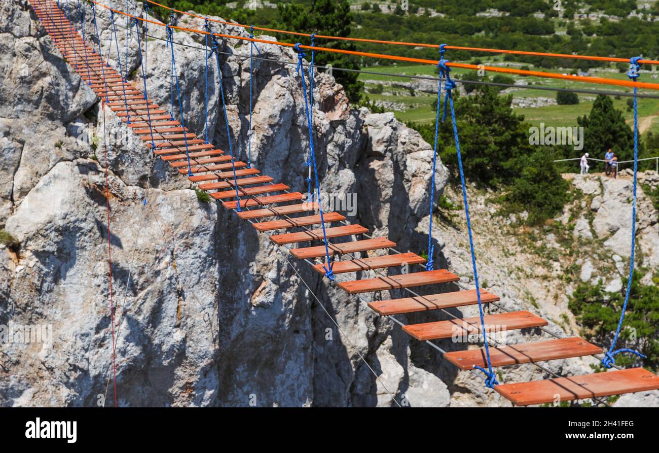 Suspension rope ladder in mountains over the chasm Stock Photo Alamy