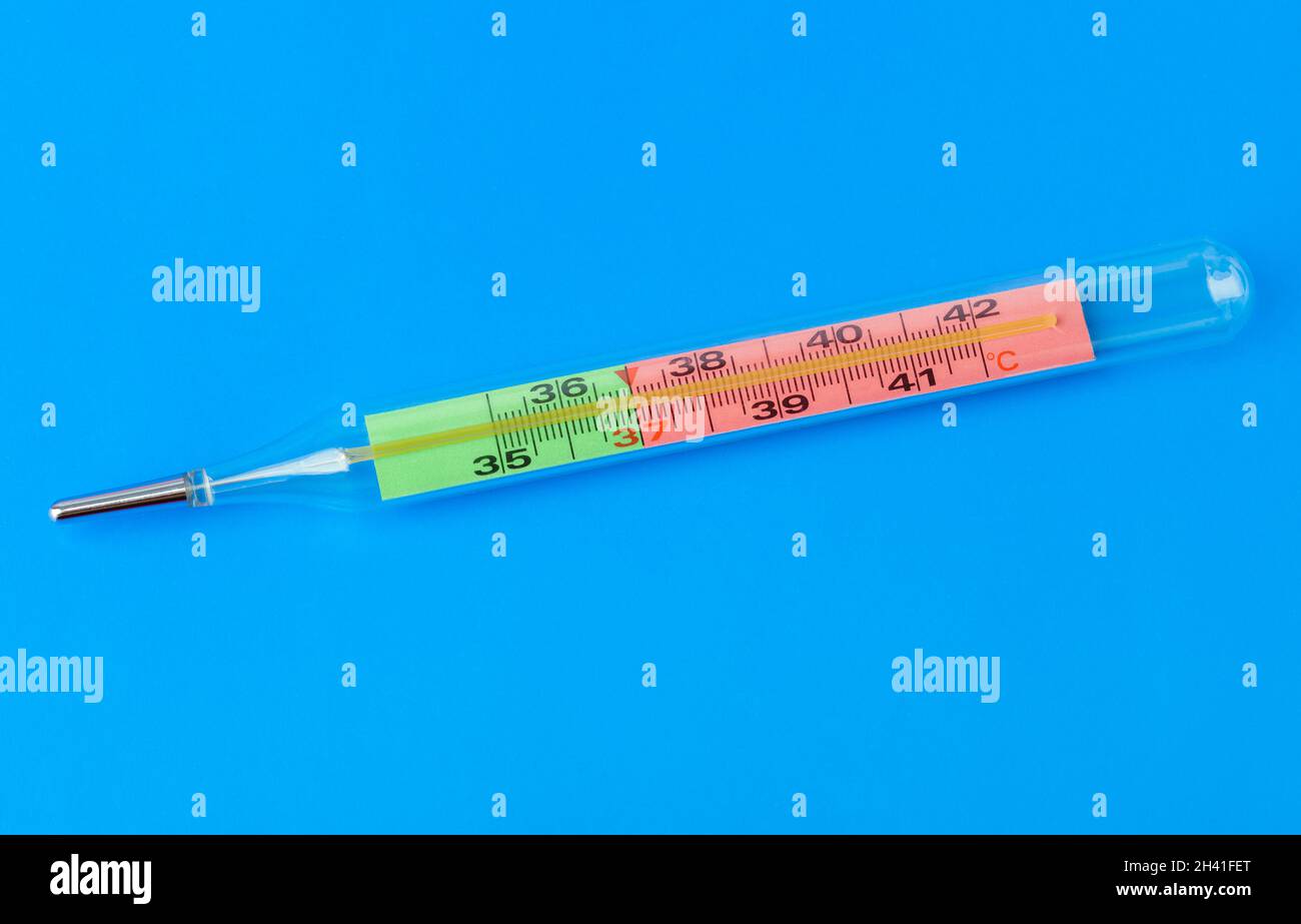 Medical thermometer on blue background Stock Photo