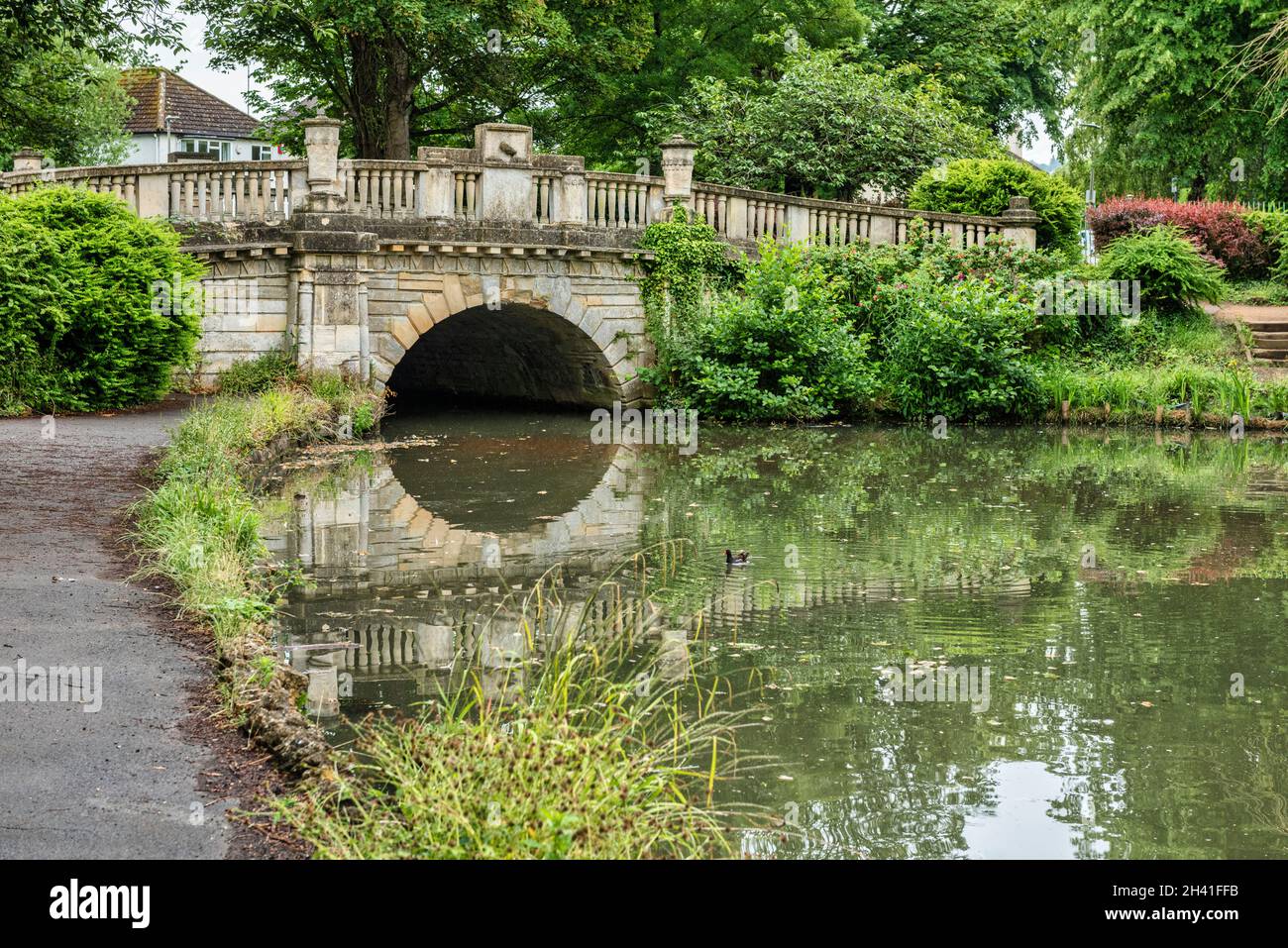 The lake and bridge in Pittville Park in Cheltenham in Gloucestershire, England Stock Photo