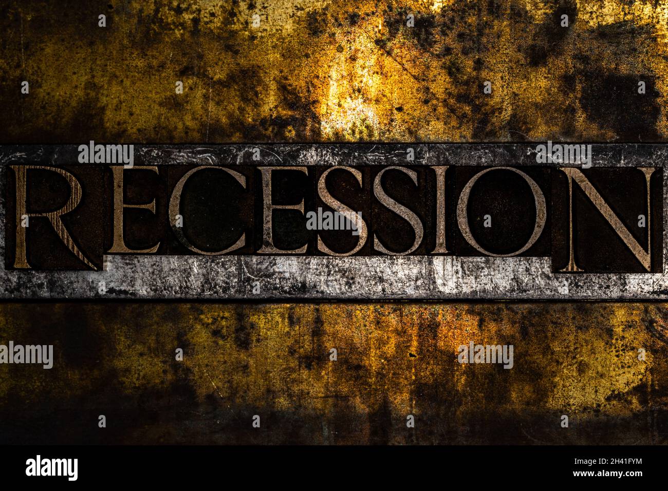 Recession text formed by real authentic typeset letters on vintage textured grunge copper and black background Stock Photo
