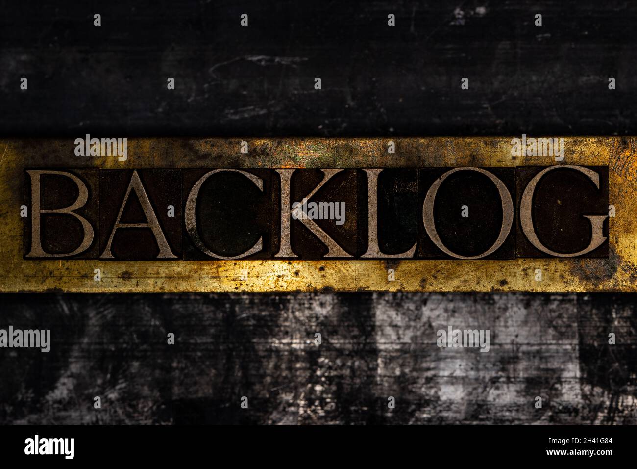 Backlog text on textured grunge copper and vintage gold background Stock Photo