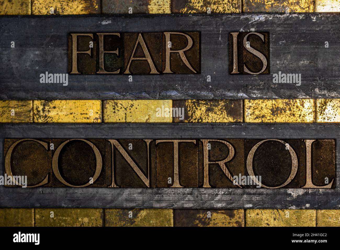 Fear Is Control text on textured grunge copper and vintage gold background Stock Photo