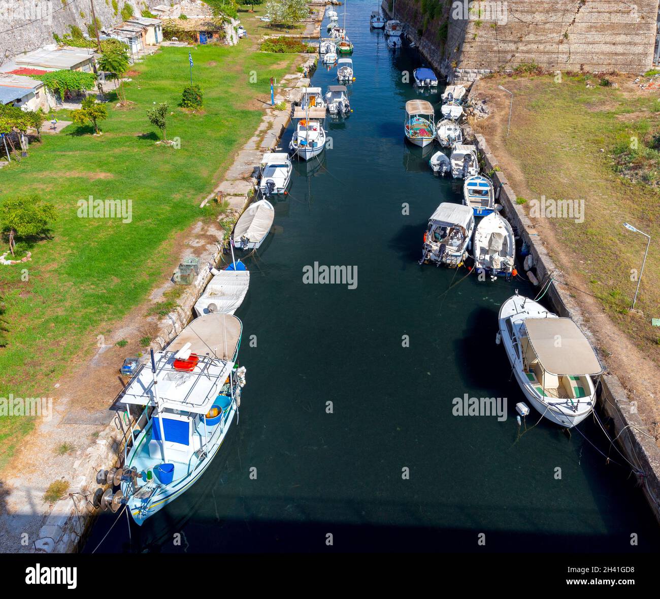 Traditional Greek fishing boats in the canal at the foot of the fort