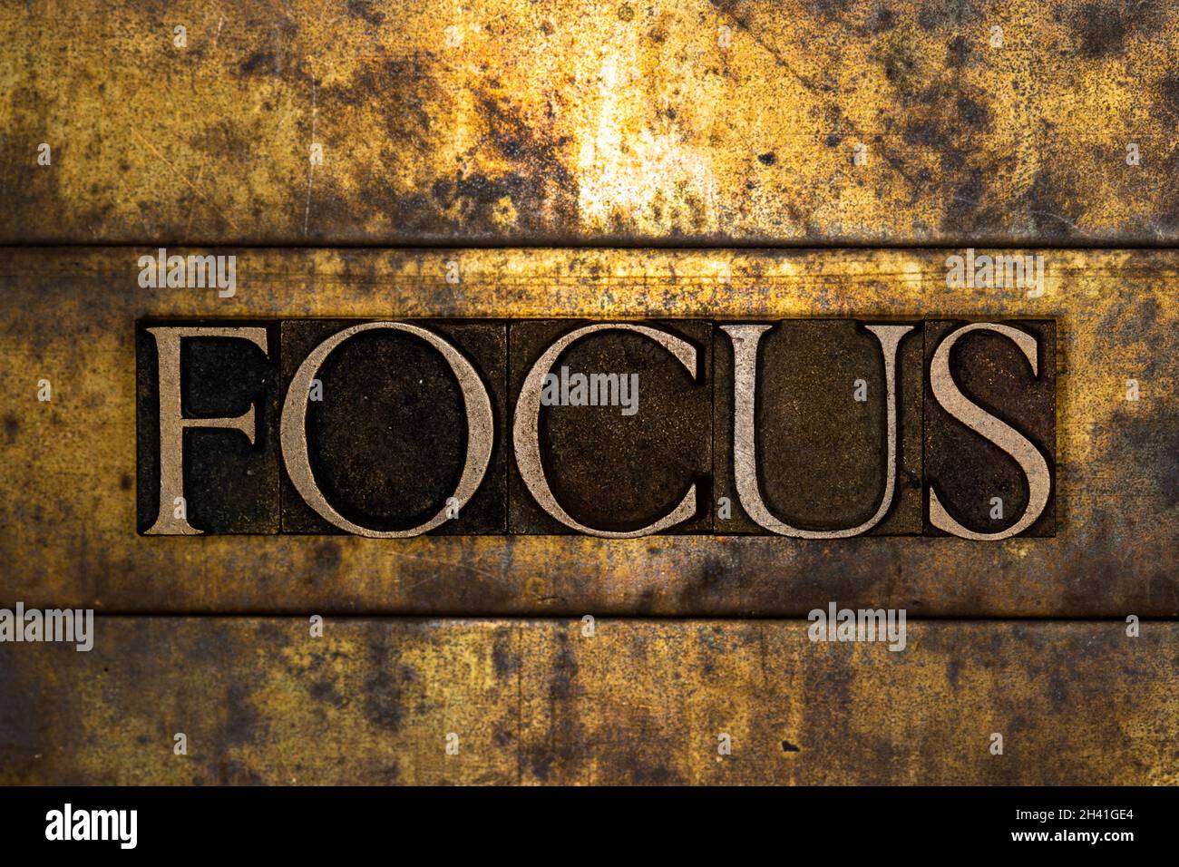 Focus text message on textured grunge copper and vintage gold background Stock Photo