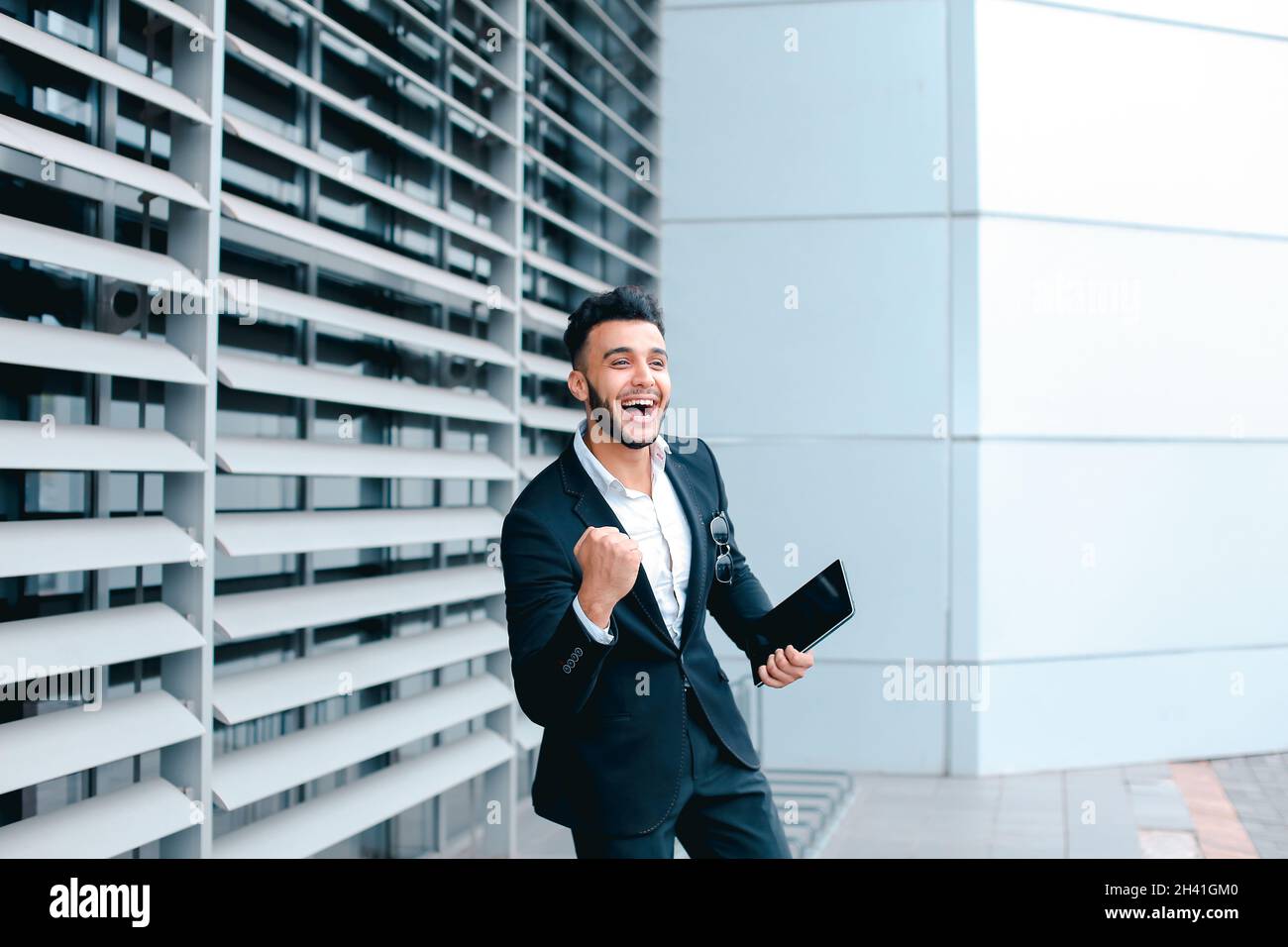 Young arabic man demonstrate shows YES business center Stock Photo