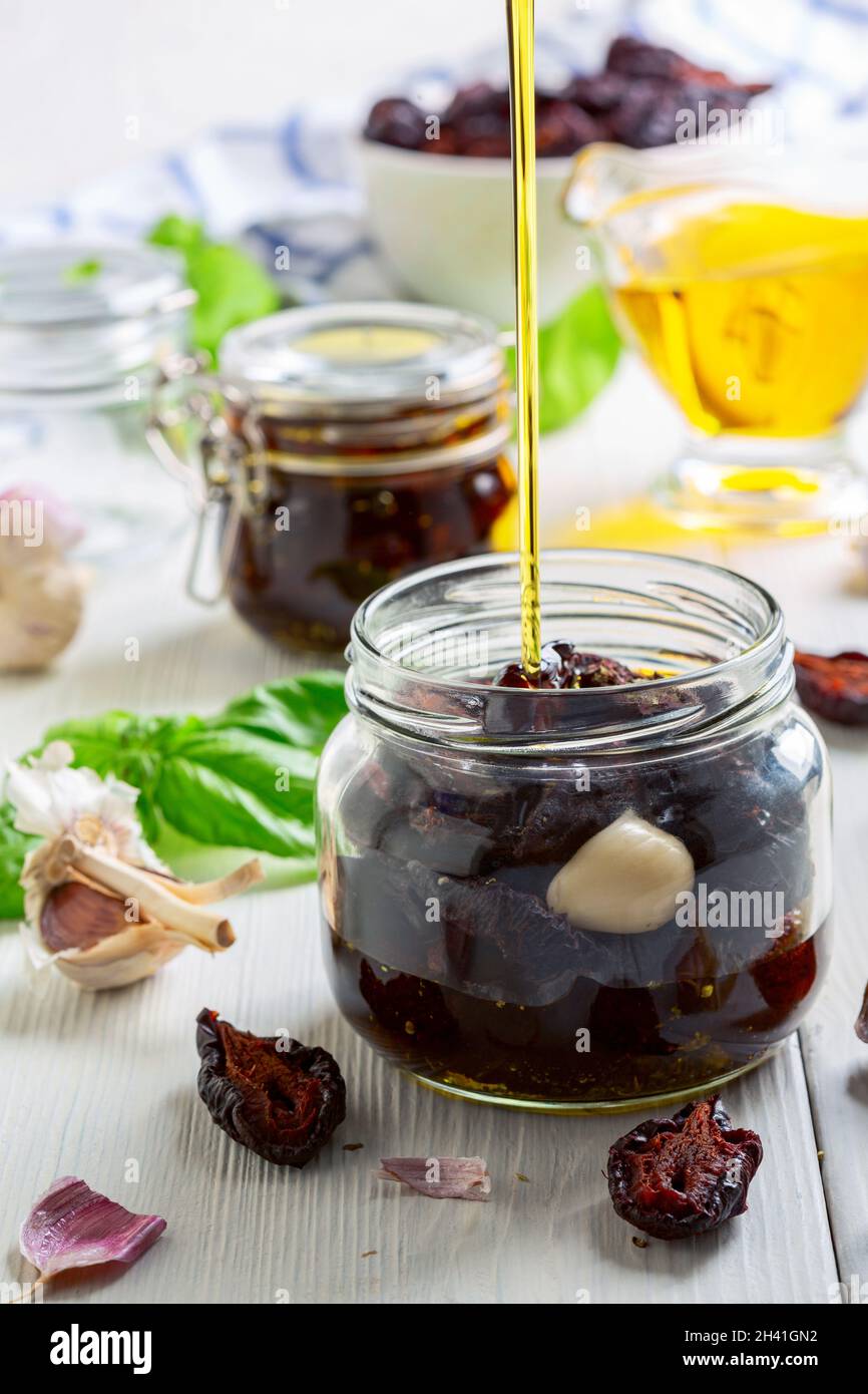 Preparation of dried plums with Italian herbs and olive oil. Stock Photo