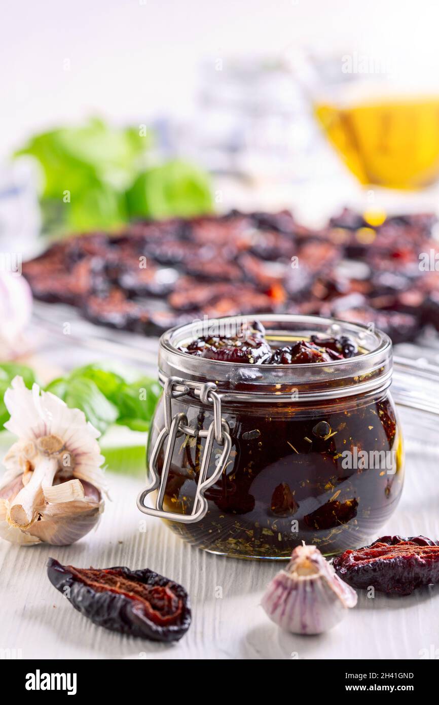 Homemade dried plums with Italian herbs and olive oil. Stock Photo