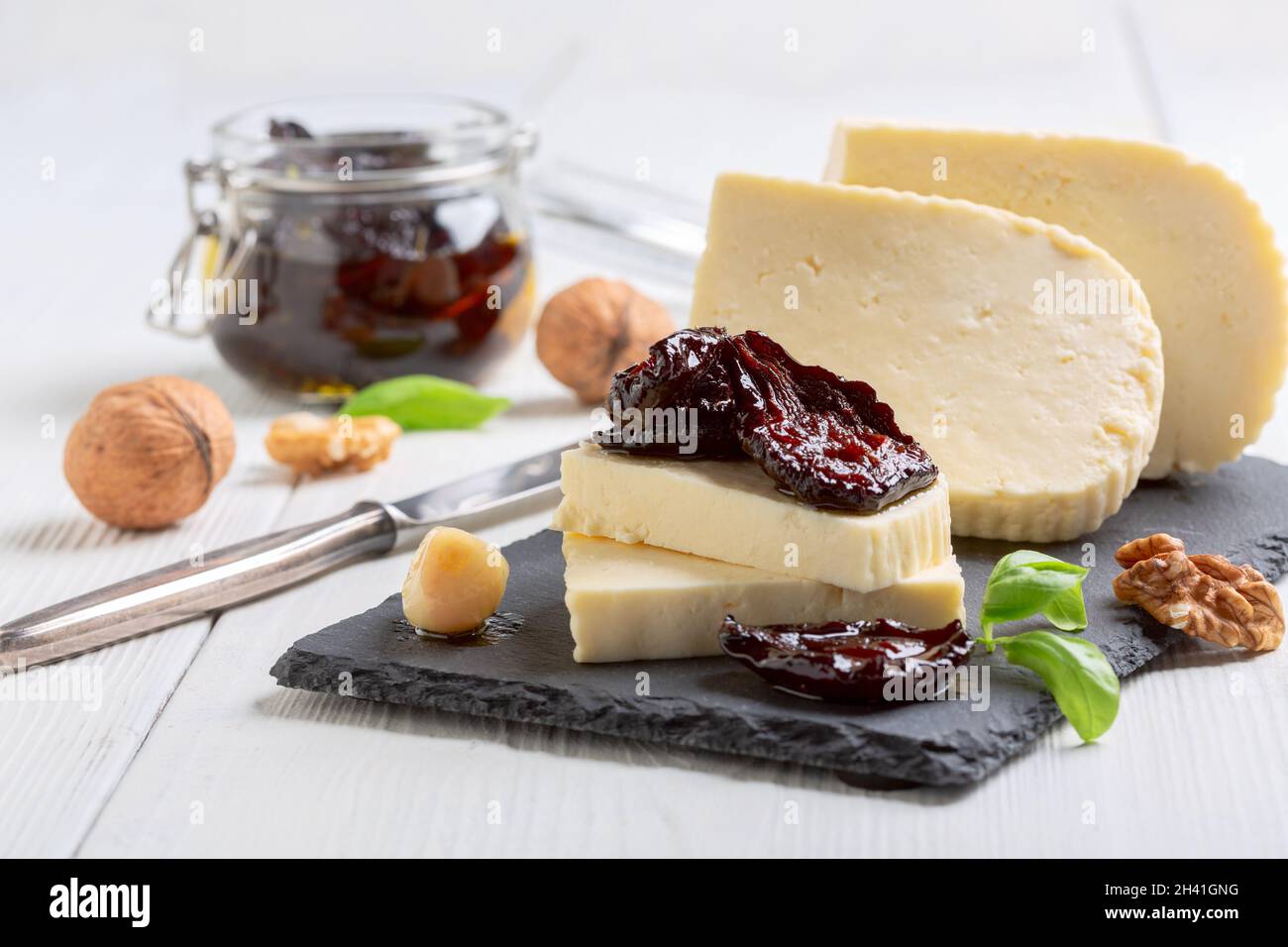 Spicy dried plums with fresh homemade cheese. Stock Photo