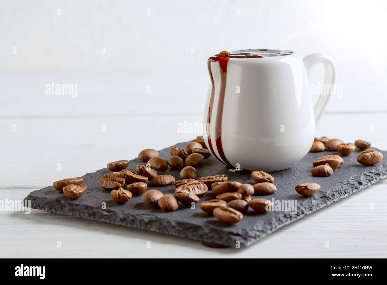 Coffee extract in a porcelain jug. Stock Photo