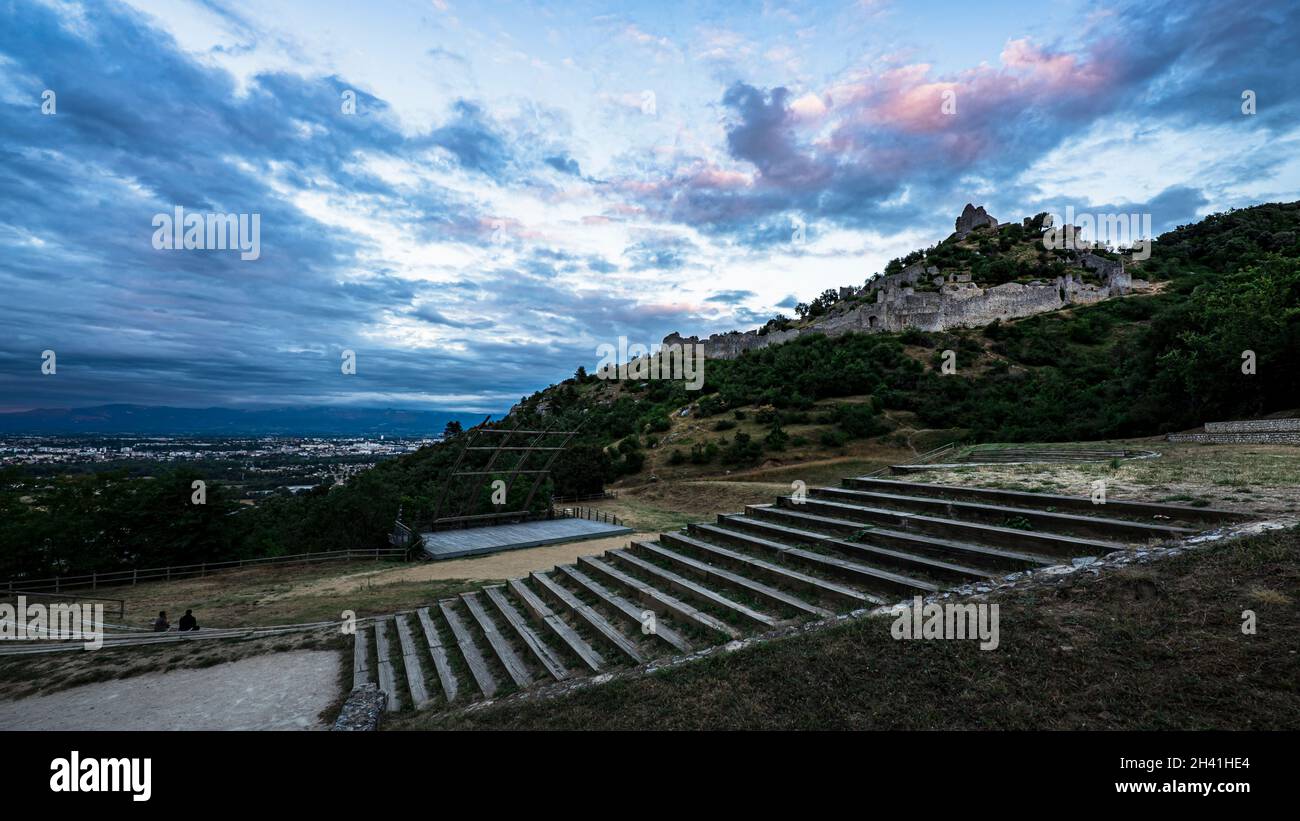 Stunning panoramic view of Valence city during sunset from Crussol lookout with amphitheater on the foreground and hill dominating castle on the backg Stock Photo