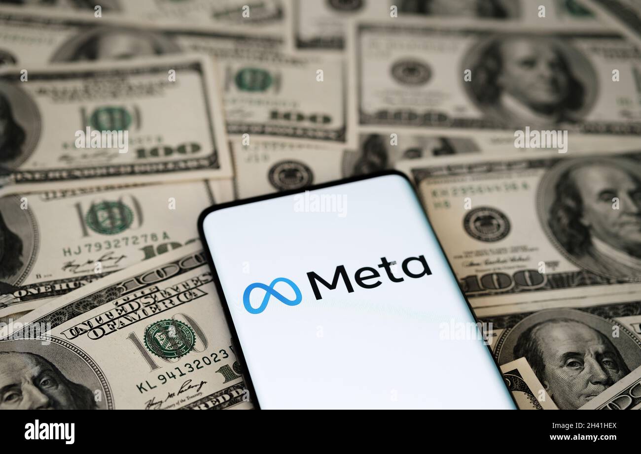 FACEBOOK META company logo seen smartphone which is placed on US dollar bills. Selective focus. Concept. Stafford, United Kingdom, October 28, 2021. Stock Photo