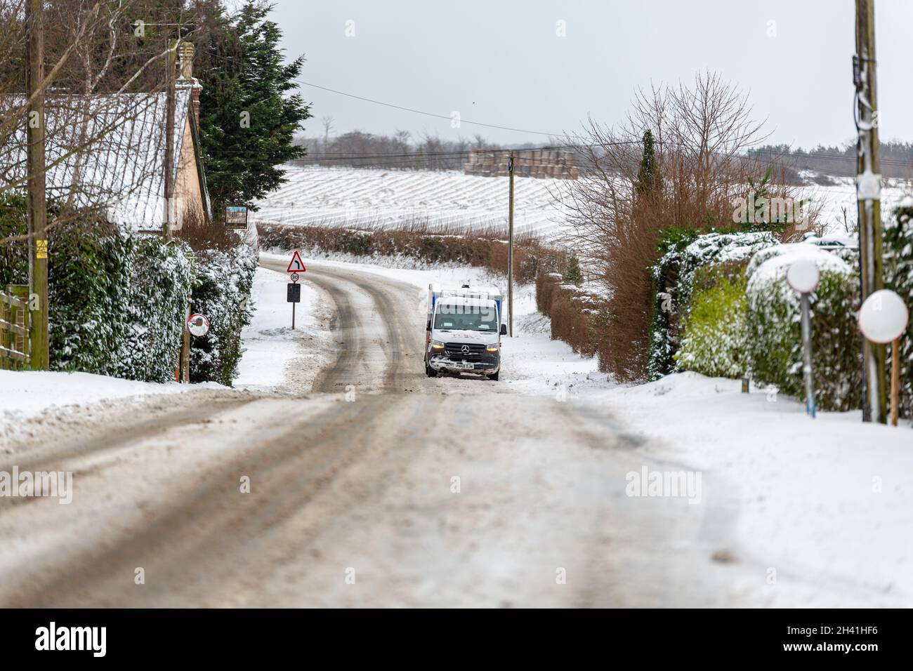 Woodbridge Suffolk UK February 08 2021: A Tesco delivery van that is stuck at the bottom of a icy hill in the countryside Stock Photo