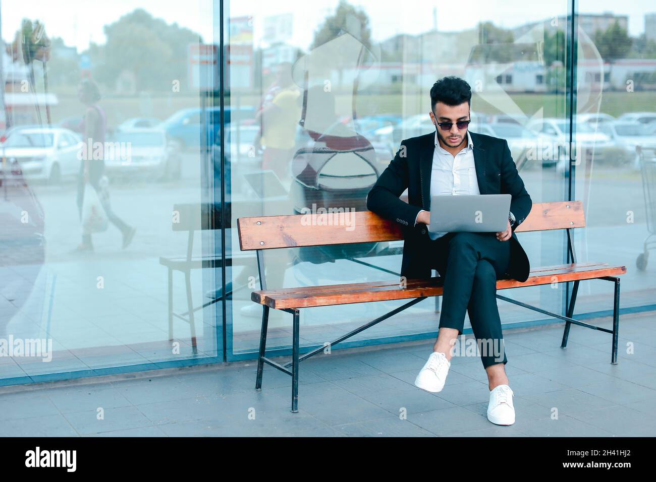 Cool guy arabic man uses laptop business center Stock Photo