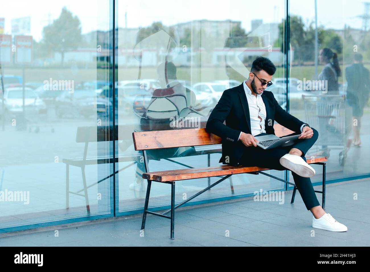 Cool guy arabic man uses laptop business center Stock Photo