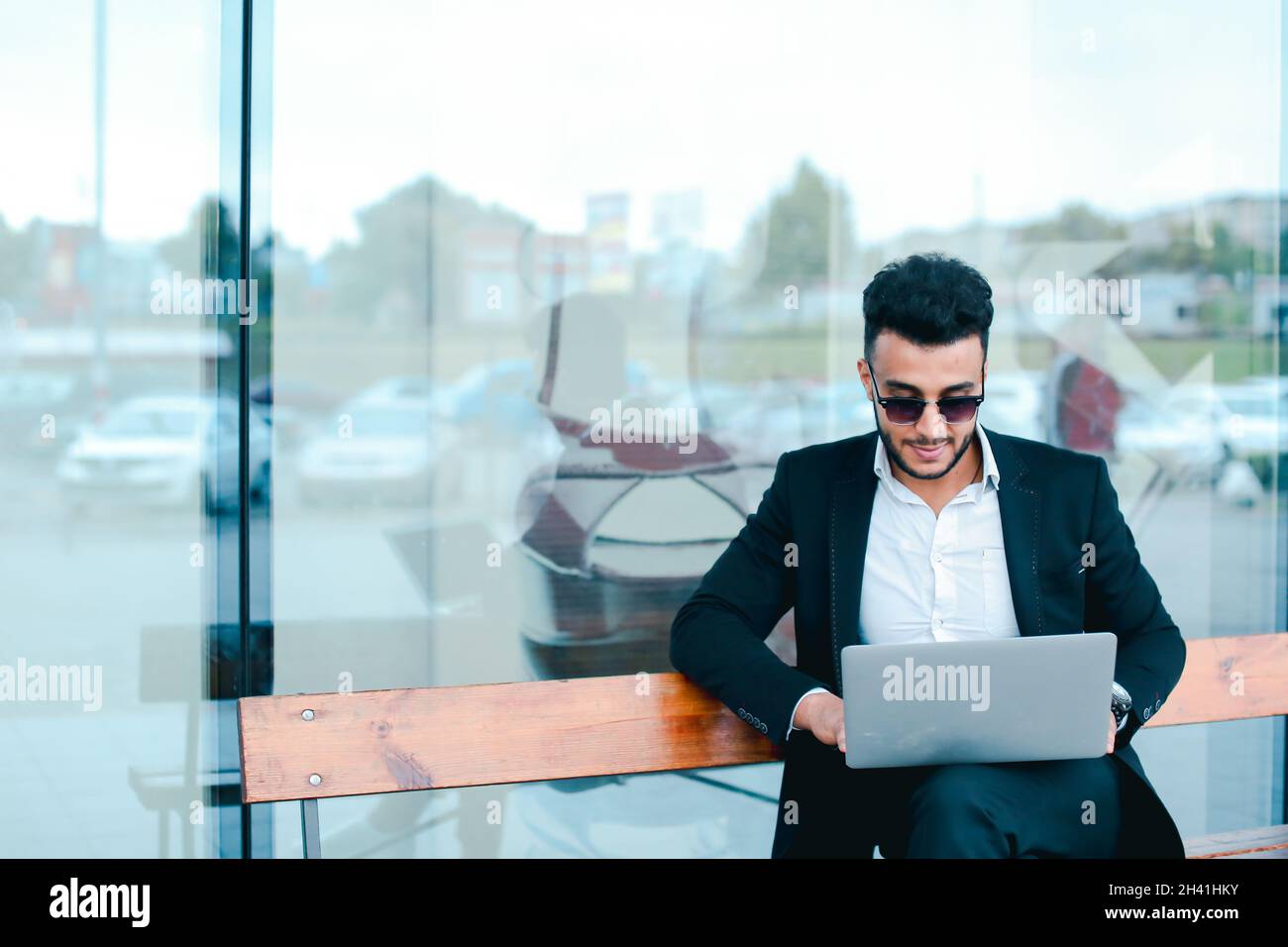 Cool guy arabic man uses laptop business center Stock Photo