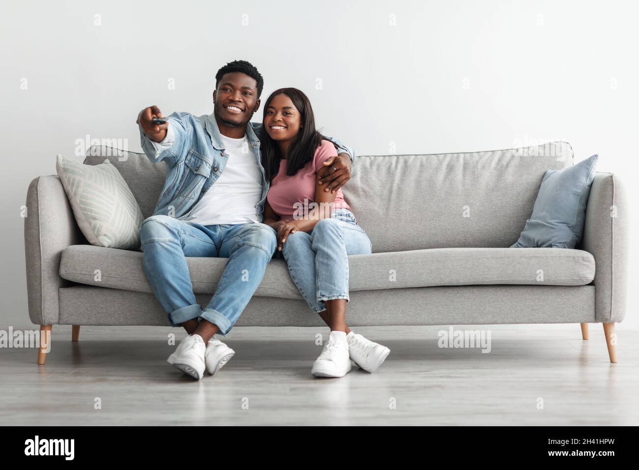 African American couple spending weekend together watching tv Stock ...
